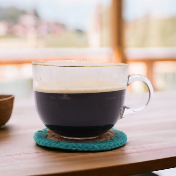 Glasunderlägg med turkos kant under kaffekopp