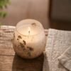 Ljus i glas med naturlig blomdekoration